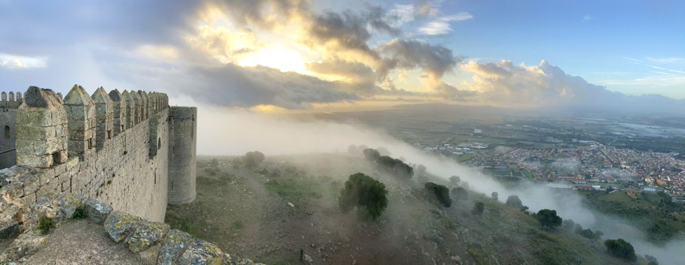 Stürmischer Sonnenaufgang am Castell del Montgrí mit Wolken und Sonne.